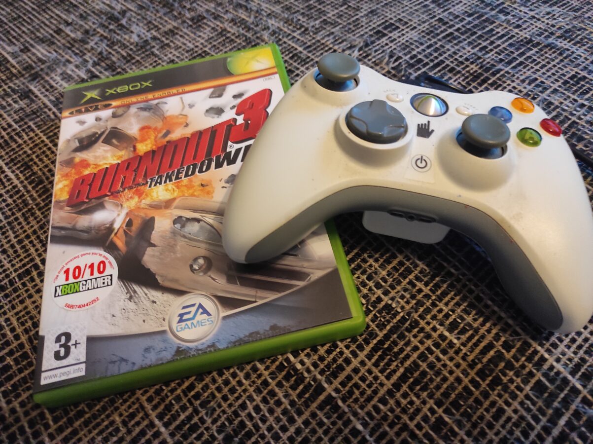 burnout 3 takedown xbox360 gamepad on a sofa