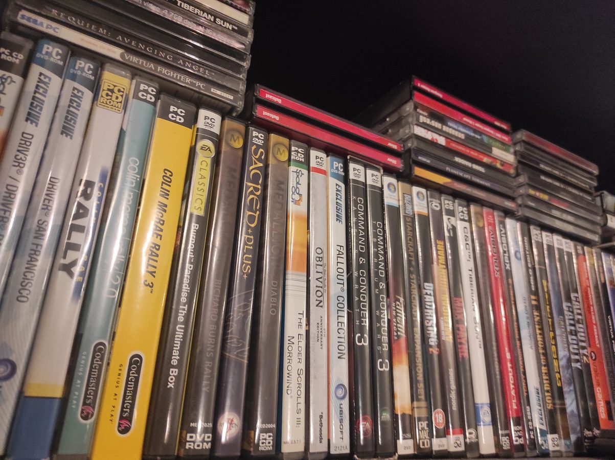 some old pc games on a bookshelf