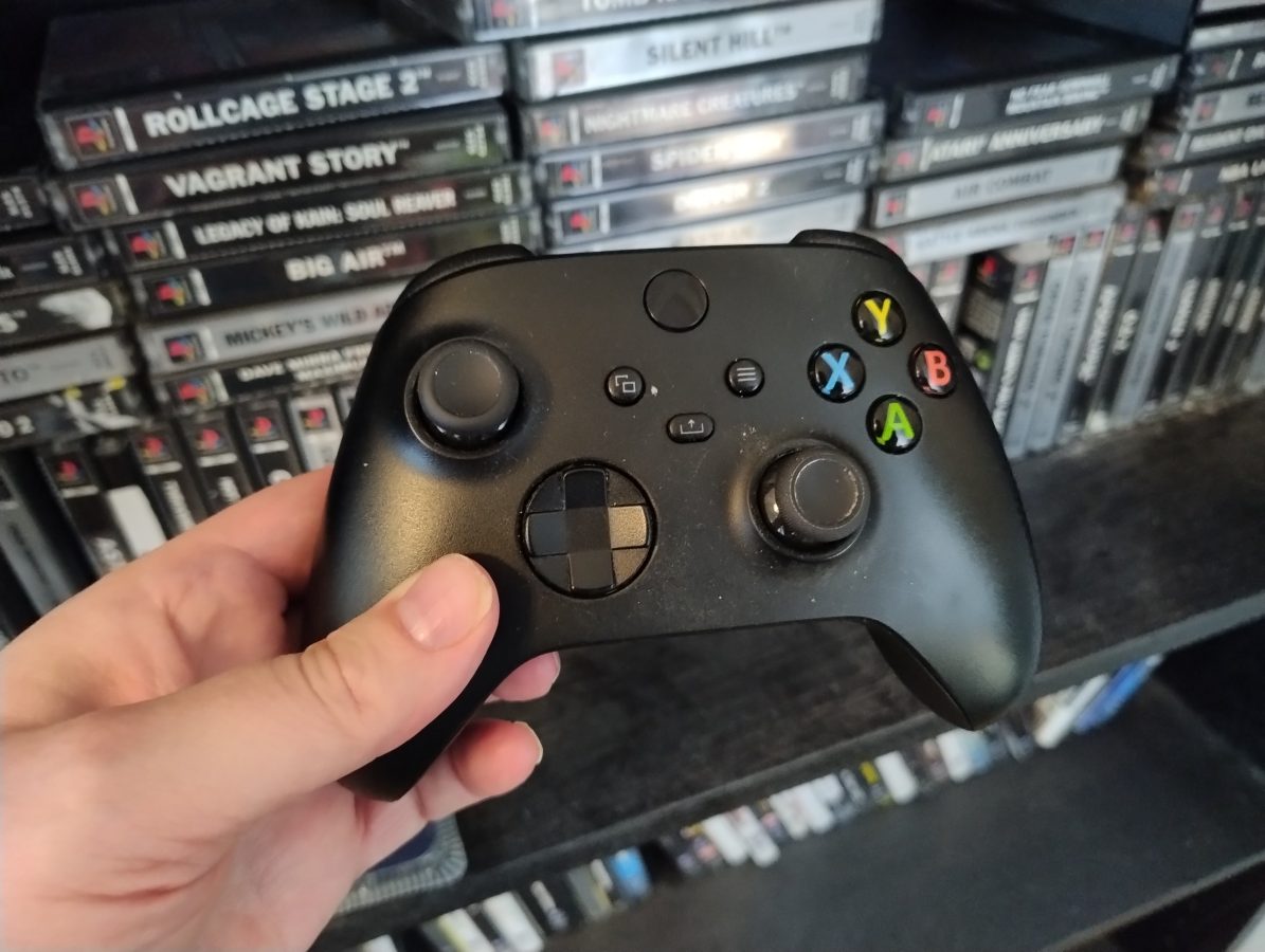 xbox controller with ps1 games on the background